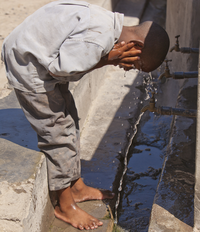 Boy washing his face Boy washing his face